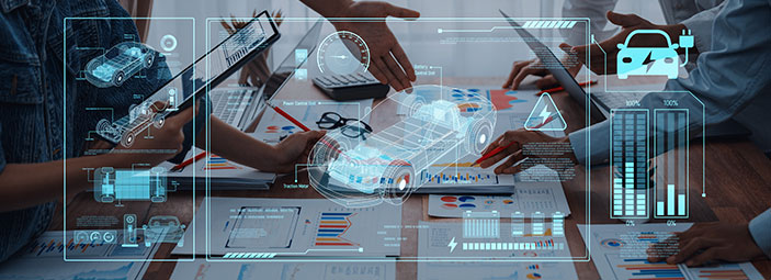 Automotive engineering team collaborating on vehicle data analytics and powertrain performance visualization using digital twin and connected vehicle insights.